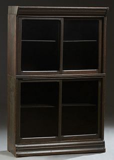 Unusual Carved Oak Barrister's Bookcase, c. 1910, the stepped top over two stacking sections with sliding glass doors, on a rounded stepped base, H.- 