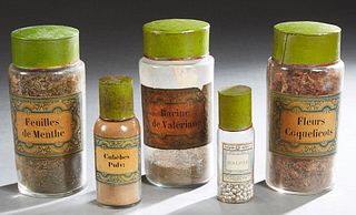 Set of Five French Glass Apothecary Bottles, 19th c., with paper labels and green tin lids, Three- H.- 9 3/8 in., Dia.- 4 in; 1- H.- 7 in., Dia.- 2 1/