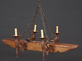French Provincial Wrought Iron and Beech Rustic Four Light Chandelier, 20th c., the four iron lights mounted on a hand hewn timber, H.- 14 in., W.- 40