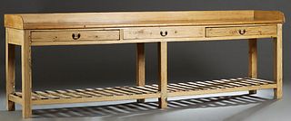 Louisiana Carved Pine Baker's Table, late 19th c., the three-quarter galleried top over three long frieze drawers, on square block legs, joined by a s