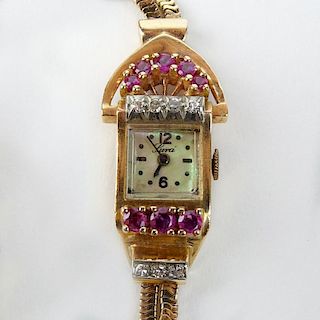 Lady's Retro 1940's 14 Karat Rose Gold, Ruby and Single Cut Diamond Bracelet Watch with Mother of Pearl Dial.