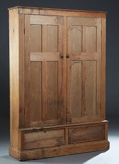 Large Louisiana Carved Pine Bookcase, late 19th c., the rounded edge crown over double paneled doors on a base with two fall front storage areas, on a