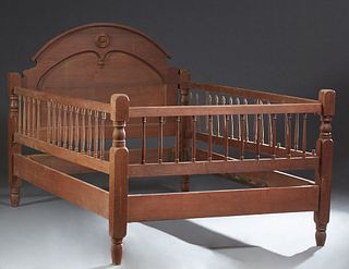 American Carved Walnut Youth Bed, late 19th c., the arched headboard with an applied roundel, to spindled rails and a spindled footboard, H.- 50 3/4 i