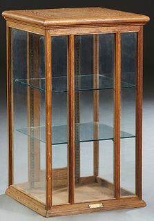 Carved Oak Tabletop Display Case, early 20th c., with a glazed top, door and sides, verso with a glazed center door and panels, with two glass shelves