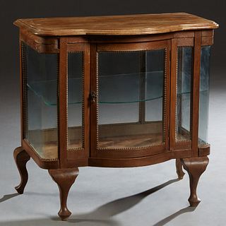 Carved Oak Bowfront Tabletop Display Case, early 20th c., the stepped rounded edge top over a curved glass center door flanked by glazed panels and cu