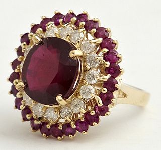 Lady's 14K Yellow Gold Dinner Ring, with an oval 9.61 carat ruby, atop a border of round diamonds, within an outer border of round rubies, total diamo