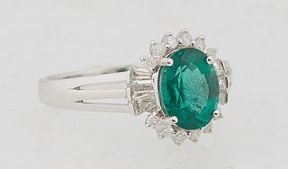 Lady's 18K White Gold Dinner Ring, with an oval 1.19 carat emerald, flanked by baguette diamonds on both sides and diamond mounted points on the top a