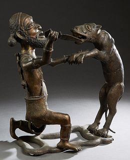African Benin Bronze Figural Group, 20th c., Nigeria, of an animal attacking a hunter, H.- 28 in., W.- 26 in., D.- 14 in. Provenance: from the Estate 