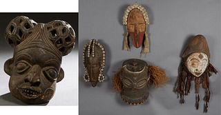Group of Five African Carved Wood Masks, 20th c., consisting of an initiation mask with a white face and a pointed headdress; a helmet mask, Pende, wi