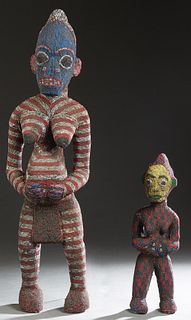Two African Carved Wood and Leather Beaded Standing Female Figures, from the Bamileke tribe, Cameroon, H.- 20 1/2 in., W.- 6 in., D.- 6 in. and H.- 38