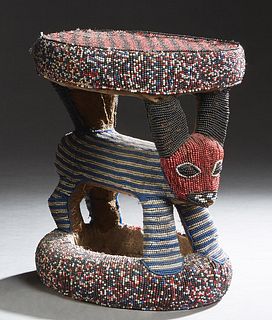 African Carved Wood Chief's Stool, 20th c., the circular top on an antelope form support on a circular base, H.- 14 1/2 in., Dia.- 12 1/2 in. Provenan