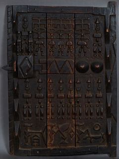 African Dgon Carved Wood Granary Door, early 20th c., with stylized relief figural carving, and sliding lock, H.- 26 1/4 in., W.- 18 in., D.- 1 1/2 in