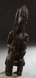African Carved Wood Ancestor Figure, 20th c., of a seated male with a cudgel and a spear, seated on a Chief's chair, H.- 48 in., W.- 14 in., D.- 18 in