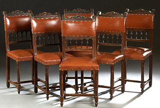 Set of Six Henri II Style Carved Walnut Dining Chairs, c. 1880, the shell carved crest rail over a leather back above a spindled panel, to a leather s