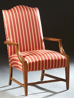 French Carved Beech Louis XVI Style Fauteuil, 20th c., the canted arched back to curved arms and a cushioned seat, on tapered square legs joined by an