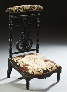 French Louis XVI Style Ebonized Oak Prie Dieu, c. 1870, the curved armrest over a pierced cruciform backsplat flanked by turned supports, to a large b