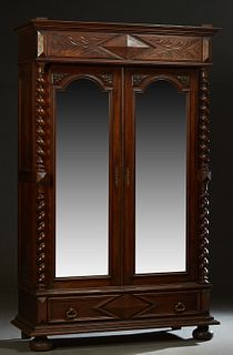 French Provincial Louis XVI Style Carved Mahogany Armoire, late 19th c., the stepped ogee crown with applied geometric carving over setback arched wid