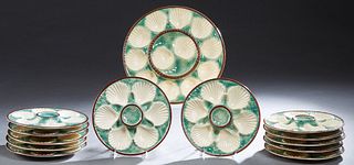 Thirteen Piece French Majolica Oyster Set, early 20th c, consisting of 12 plates and a matching platter, Plates- H.- 1 in., Dia.- 9 1/2 in. (13 Pcs.)