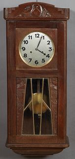 French Art Deco Carved Oak Wall Clock, c. 1940, time and strike, the geometric carved case with beveled glass panels, with pendulum, H.- 32 in., W.- 1