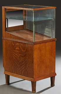 Carved Oak Freestanding Pen Display Case, c. 1910, with a glass top and three glass sides, one side with a sliding oak door, on an oak base, on tapere