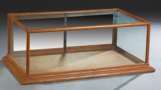 Carved Oak Table Top Display Case, early 20th c., with a glazed top and three sides, the rear with two sliding oak door, on a stepped plinth base, H.-