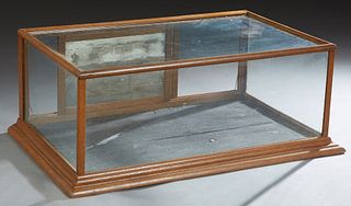 Carved Oak Tabletop Display Case, early 20th c., with a glass top, front and sides, verso with two sliding doors, H.- 17 1/2 in., W.- 45 1/2 in., D.- 