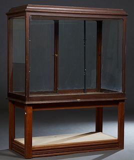 Large Carved Mahogany Display Cabinet, early 20th c., by G. Evans, with glass sides a front, the rear with double glass doors, now on a later cypress 