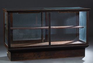 Large Carved Oak Store Counter Display Case, early 20th c., the top with two inset glass panels over a glass front and sides, verso with sliding glass