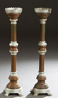Pair of Metal Altar Candlesticks, early 20th c., the scalloped candle cup on a knopped support to a sloping circular socle, on four paw feet, H.- 37 i
