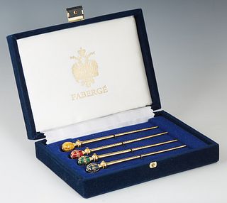 A Set of Four Gilt Metal, Enamel and Clear Paste Hat Pins by Faberge Imperial Collection, of recent manufacture, in original blue velvet presentation 
