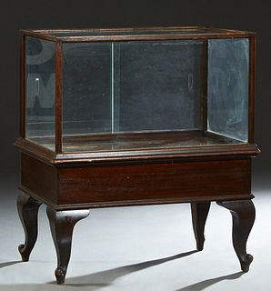 American Carved Oak Display Case, with a glass top front, sides and two rear sliding glass doors, on cabriole legs with toupie feet, H.- 40 1/2 in., W