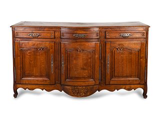 A Louis XV Provincial Style Carved Oak Buffet
Height 43 x width 78 1/2 x depth 20 1/2 inches.