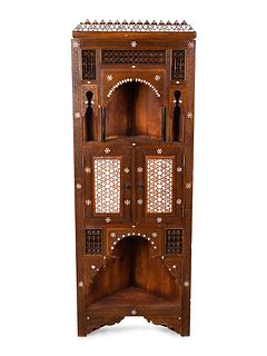 A Syrian Inlaid and Carved Wood Corner Cabinet
Height 69 1/2 x width 25 x depth 14 inches.
