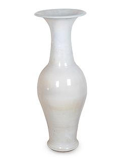A Large Chinese White-Glazed Porcelain Vase
Height of vase 42 x diameter 14 1/2 inches. Height of stand 12 1/2 x diameter 18 inches.