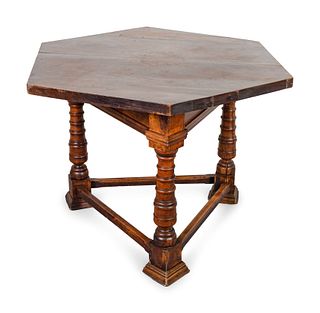 An Italian Baroque Style  Walnut Hexagonal Table on Tripartite Base
Height 31 1/4 x diameter 47 inches.ches.