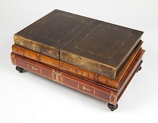 A leather bound book-form cocktail table