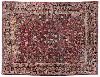 A large Persian Sarouk woolen rug