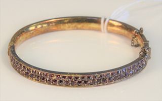Two piece lot including a 10 Karat Bangle Bracelet
set with garnets, in a box with Card of Hotel Palace, Praha 
marked Prague on back, and a gold plat
