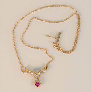 14 Karat Yellow Gold Chain with Pendant
set with ruby and fifteen diamonds
length 14 1/2 inches
6.2 grams total weight
Provenance: The Estate of Diana