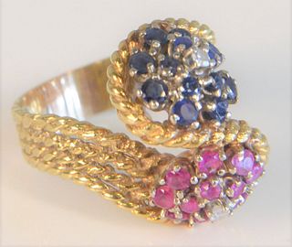 18 Karat Gold Ring
rope design with blue sapphire head and ruby head
size 7 3/4, 12.6 grams total weight
Provenance: From the Lance & Irma Keller Coll