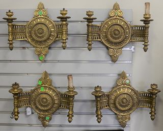Set of Four Louis XVI Style Bronze Dore Two-Light Wall Sconces
having circular center with articulated arm holding torchiere
height 13 1/2 inches, len