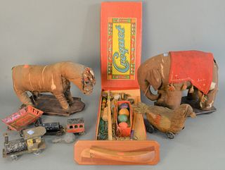 Group of toys, elephant pull toy, horse pull toy, chicken pull toy, tin toy train, half hull 
Provenance: The Estate of Diana Atwood Johnson