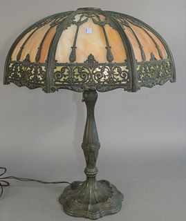 Slag Glass Table Lamp
having eight carmel and green glass panels, on bronze base
one broken panel
height 26 inches, width 21 inches
Provenance: Thirty