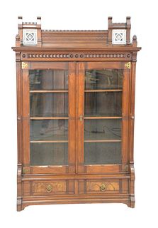 Aesthetic Walnut Bookcase
having two inlaid tiles, in gallery over two doors, over two drawers
height 73 inches, width 48 inches, case depth 12 inches