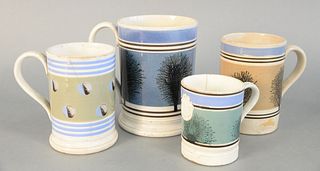 Lot of Four Mocha Mugs
to include: two with tree decoration, one with makers mark
heights 3 3/4 inches and 6 inches
along with one with trees and band