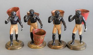 Four Blackamoor Figures 
carrying baskets to be toothpick holders, one missing a left arm
height 4 1/2 inches
Provenance: The Gloria Schiff Estate, Ne