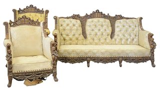 Carved Sofa and Two Chairs
each with carved putti, cornucopia, fruit, and music
in need of upholstery and cushions
