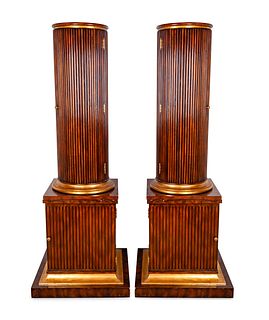 A Pair of Regency Style Fluted Mahogany Columnar CabinetsHeight 73 x diameter 15 inches; width of base 27 x depth 27 inches.