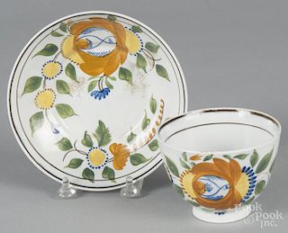 Leeds pearlware cup and saucer, 19th c., with floral decoration.