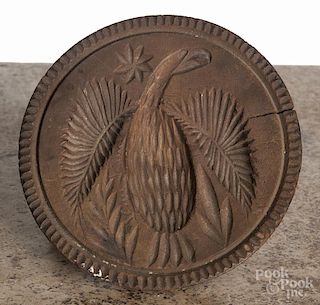 Four carved wood butter prints, 19th c., two with eagle design, largest - 5'' dia.